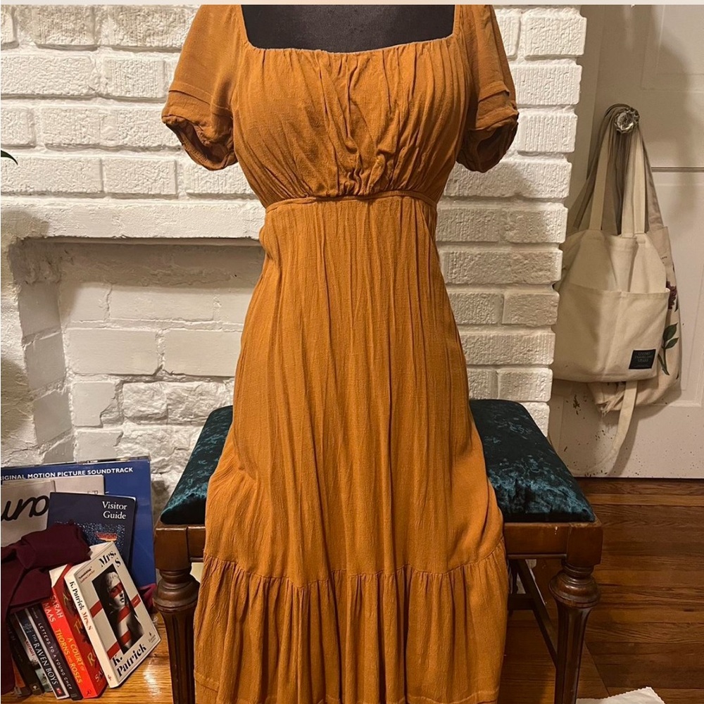 Long linen sunset colored orange/yellow dress that ties in the back. 🌅